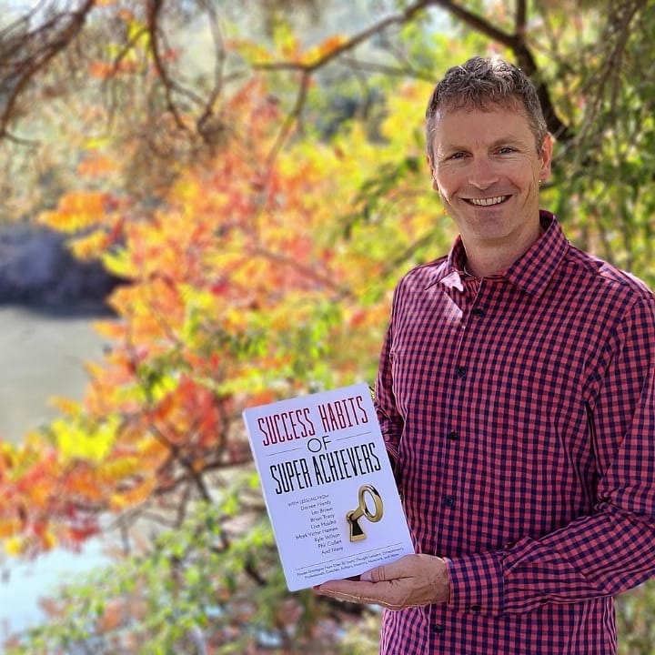Rick Gray holding his Amazon #1 Best-Selling book Success Habits of Super Achievers